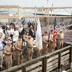 Veterans and guests stand for presentation of colors on dock at Mayflower II.