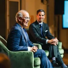 Seated David Brooks and Jared Bowen in conversation at Museum event.