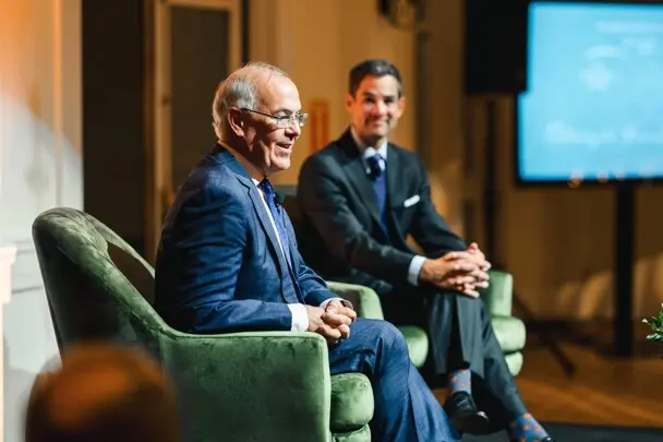 Seated David Brooks and Jared Bowen in conversation at Museum event.