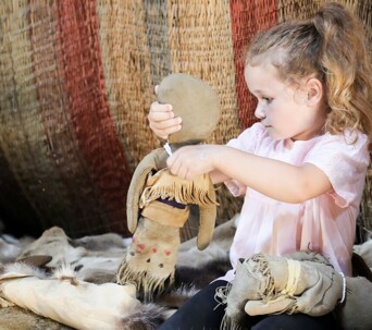 Young girl learns in wetu.