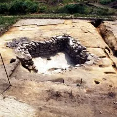 The stone base of a house uncovered on the Allerton-Cushman Site is sectioned off.