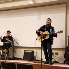 Three members of Lone Wolf and the Spaghetti Corner Band perform on stage.