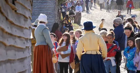 Crowds of Museum guests interact with Pilgrims at the 17th-Century English Village.