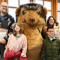 A family poses with Hedgie.