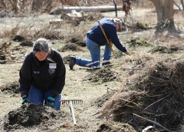 Trsutee volunteers hoemsite clean up day