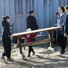 Volunteers carry bench fort clean up day