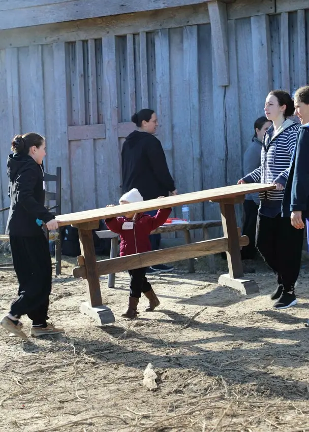 Volunteers carry bench fort clean up day