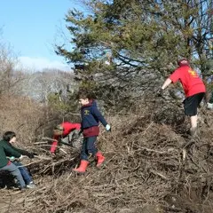 Young volunteers stick pile clean up day