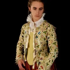 A woman models the Plimoth Jacket and 17th century clothing.