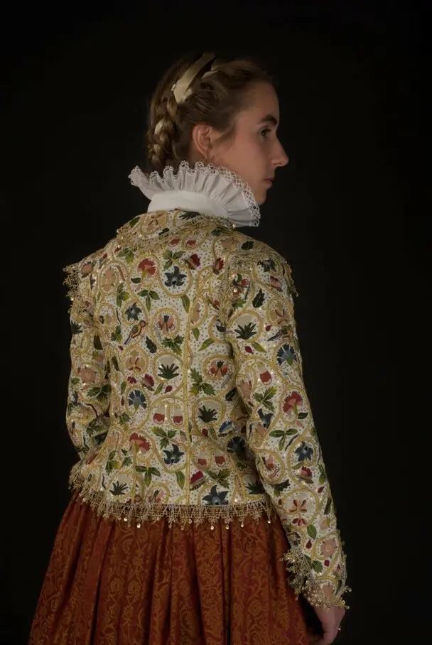 A woman models the Plimoth Jacket and 17th century clothing.