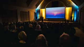 Movie goers look at a screen in Plimoth Cinema.