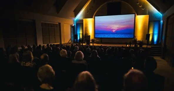 Movie goers look at a screen in Plimoth Cinema.