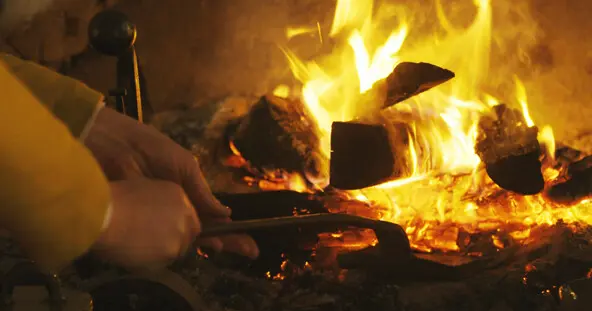 English village hearth tending fire