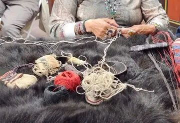 Indigenous Museum Educator demonstrates Indigenous craft