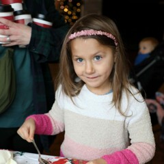 Girl decorates a holiday cookie.