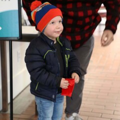 Young boy holds a magical bell.