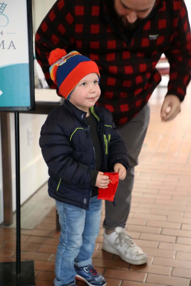 Young boy holds a magical bell.