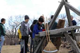 A group of young volunteers work together in the 17th-Century English Village.