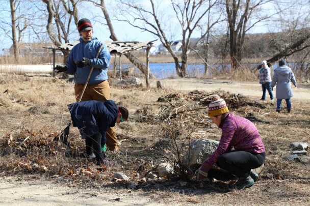 A couple weed the garden at the Historic Patuxet Homesite with their young daughter.