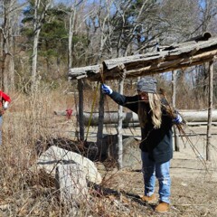 A woman weeds the garden on the Historic Patuxet Homeiste by the Shade Arbor.