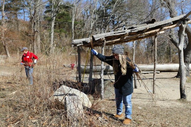 A woman weeds the garden on the Historic Patuxet Homeiste by the Shade Arbor.