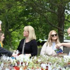 Horticulturist speaks with shoppers at plant sale