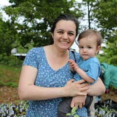 Mother poses with toddler son at plant sale