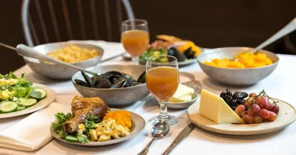 Thanksgiving table set with food inspired by historical recipes