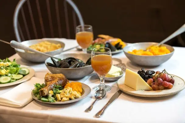 Thanksgiving table set with food inspired by historical recipes