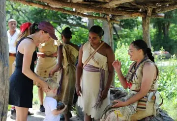 Mother and child guest engage with Educators at the Shade Arbor on the Historic Patuxet Homesite