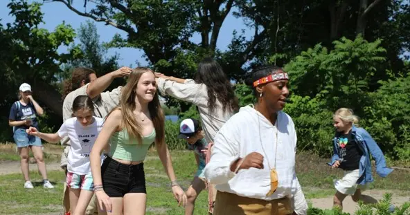Guests and Educators take part in a traditional Wampanoag dance on the Homesite.