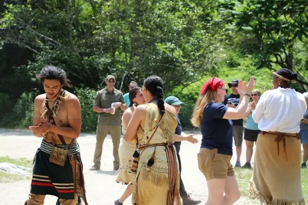 Educators demonstrate a traditional Wampanoag dance in front of guests at the Homesite on Strawberry Thanksgiving