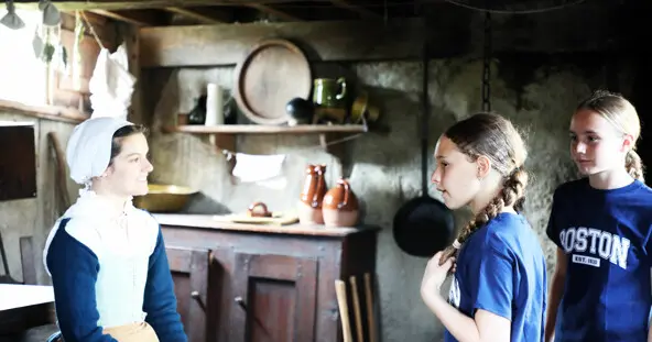Pilgrim interior village house girls talking