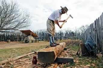 English village pilgrim working log axe chopping wood