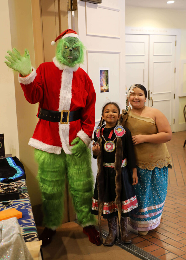 The Grinch poses with two young members of Wetu Ways.
