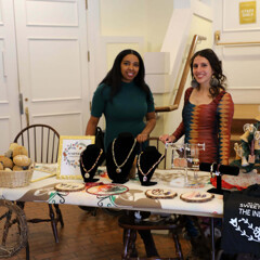 The founders of Juniper and Pine Collective stand behind their table featuring handmade items at the Winter Fine Arts & Craft Fair.