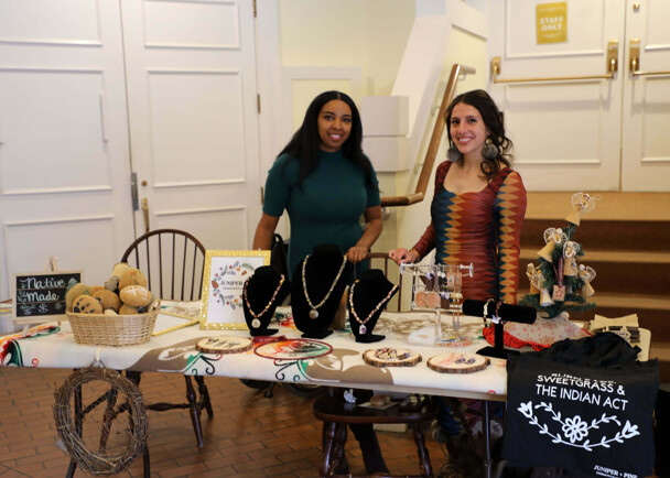The founders of Juniper and Pine Collective stand behind their table featuring handmade items at the Winter Fine Arts & Craft Fair.