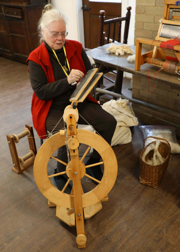 A textile artisan demonstrates her craft.