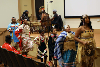 Members of Wetu Ways demonstrate a dance in front of the stage in Plimoth Cinema