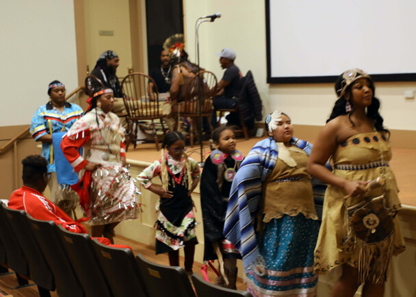 Members of Wetu Ways demonstrate a dance in front of the stage in Plimoth Cinema