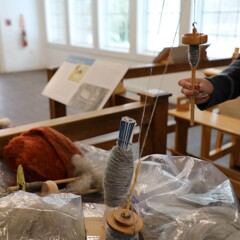 Educator spins wool in Craft Center.
