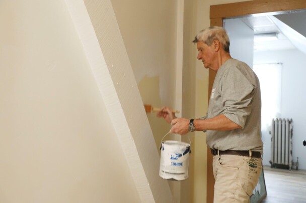 Volunteer paints craft center