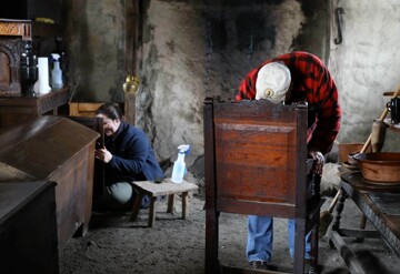 Volunteers polish pilgrim furniture
