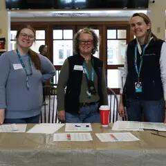 Three staffers stand ready to check-in Museum Clean Up Day Volunteers