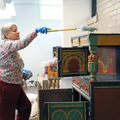 Volunteer dusting craft center