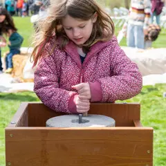 Young learner grinds corn