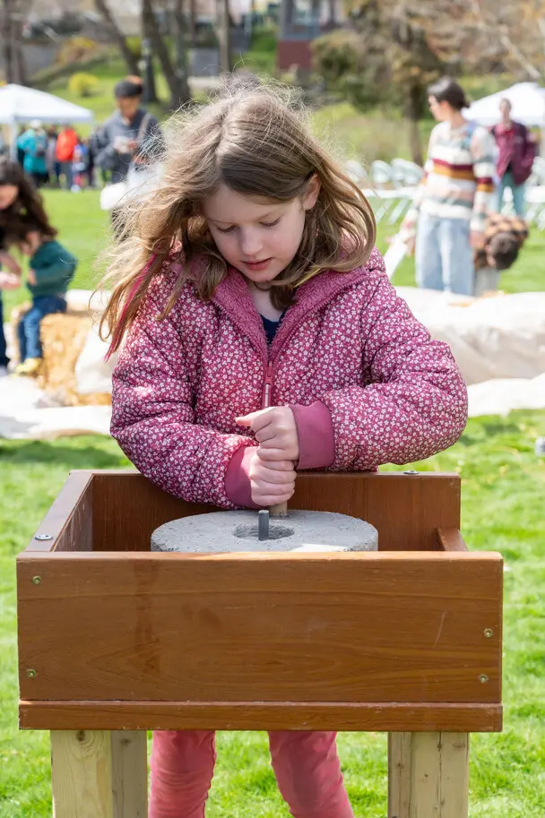 Young learner grinds corn