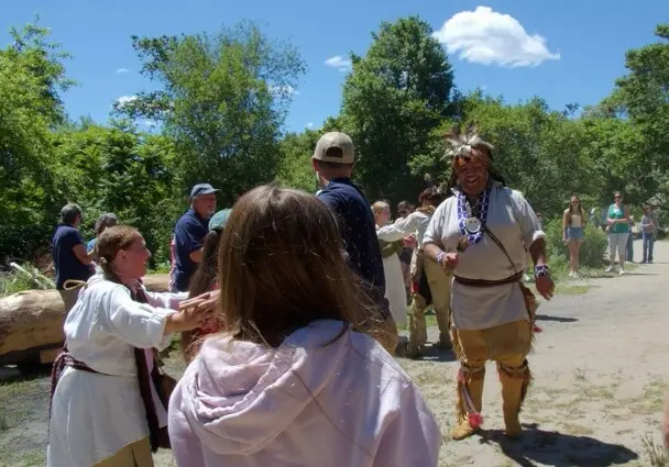 Culture keepers and guests on the Historic Patuxet Homesite engage in a traditional Wampanoag dance