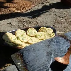 Wampanoag corn cakes placed in a wooden bowl, waiting to be cooked