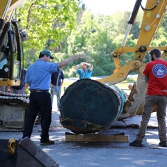Plimoth patuxet museum staff moving mishoon log
